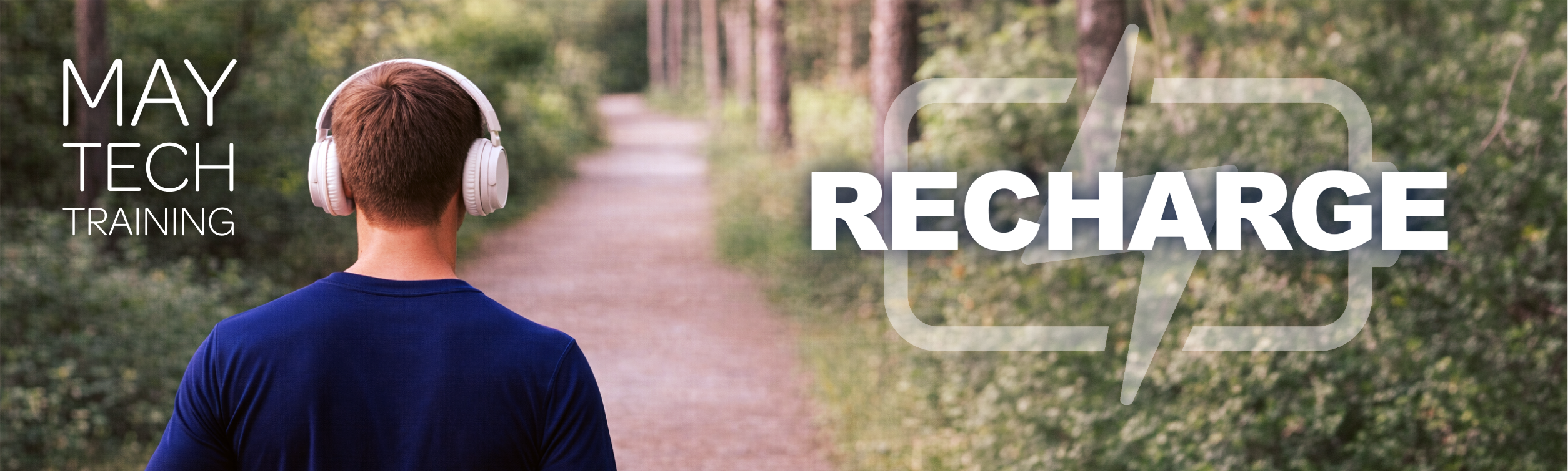 Back view of a person wearing white headphones walking on a wooded path; overlay text reads “May Tech Training” and “Recharge” with a battery symbol.
